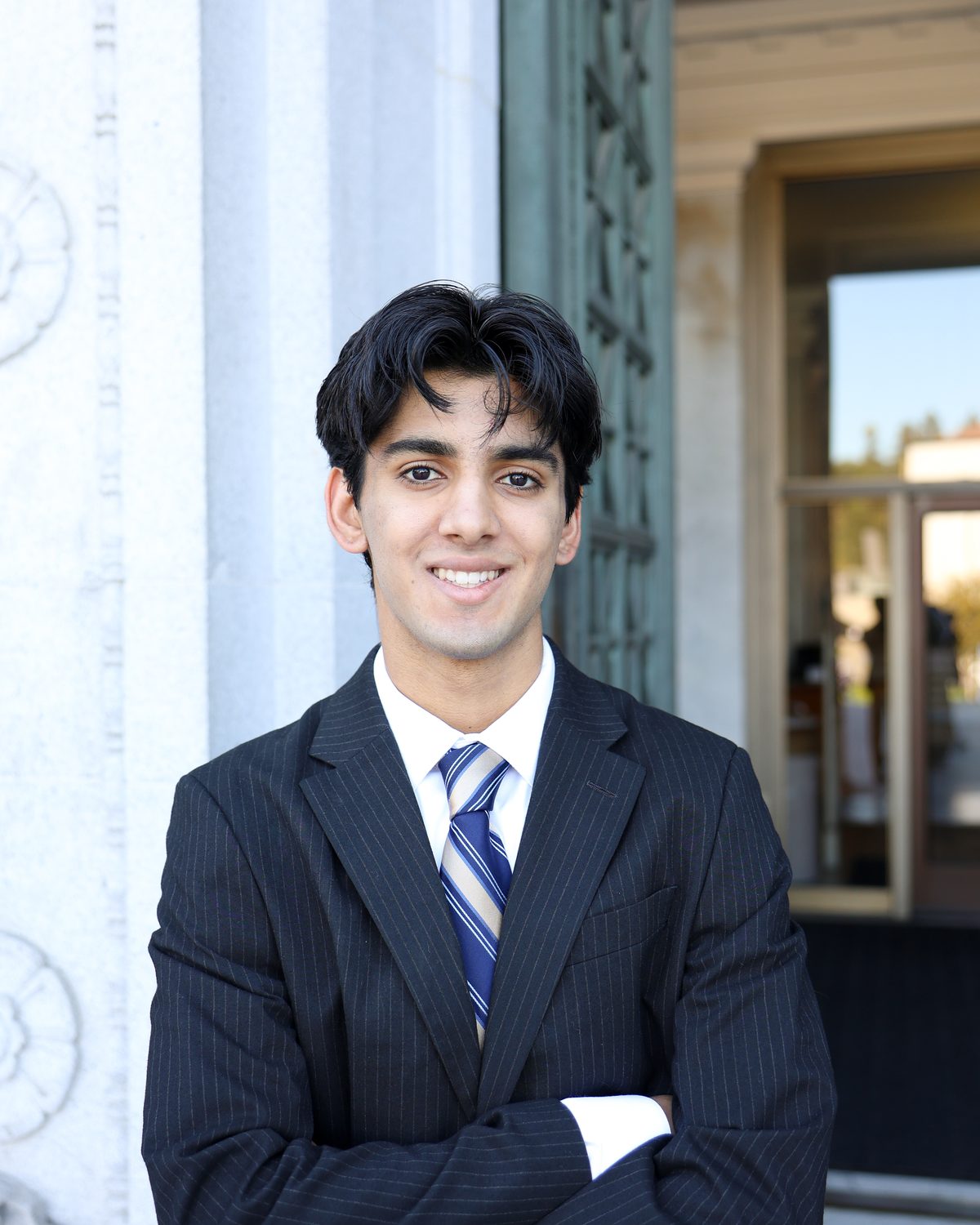 Rayan Garg in a suit on the UC Berkeley campus